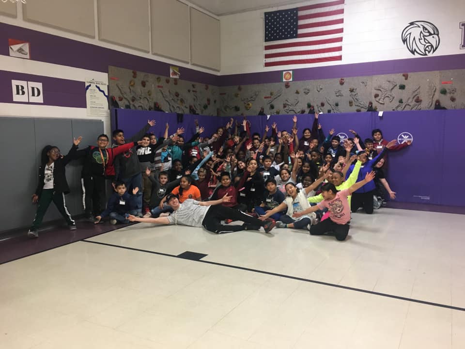 Elementary school students cheering after a Big Blue Handball clinic in their gym